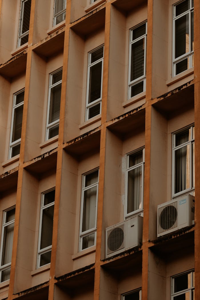 Detailed view of a building facade in Curitiba with air conditioning units.
